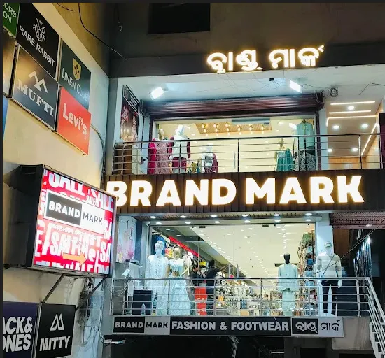 The Brand Mark storefront at Spectrum Center, Berhampur, lit up at night